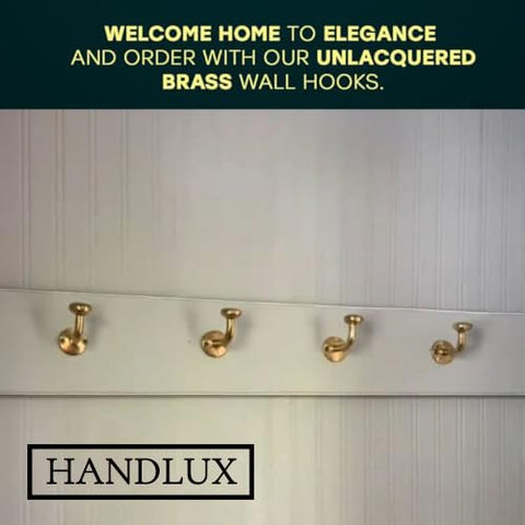 HANDLUX unlacquered brass wall hook holding towels neatly