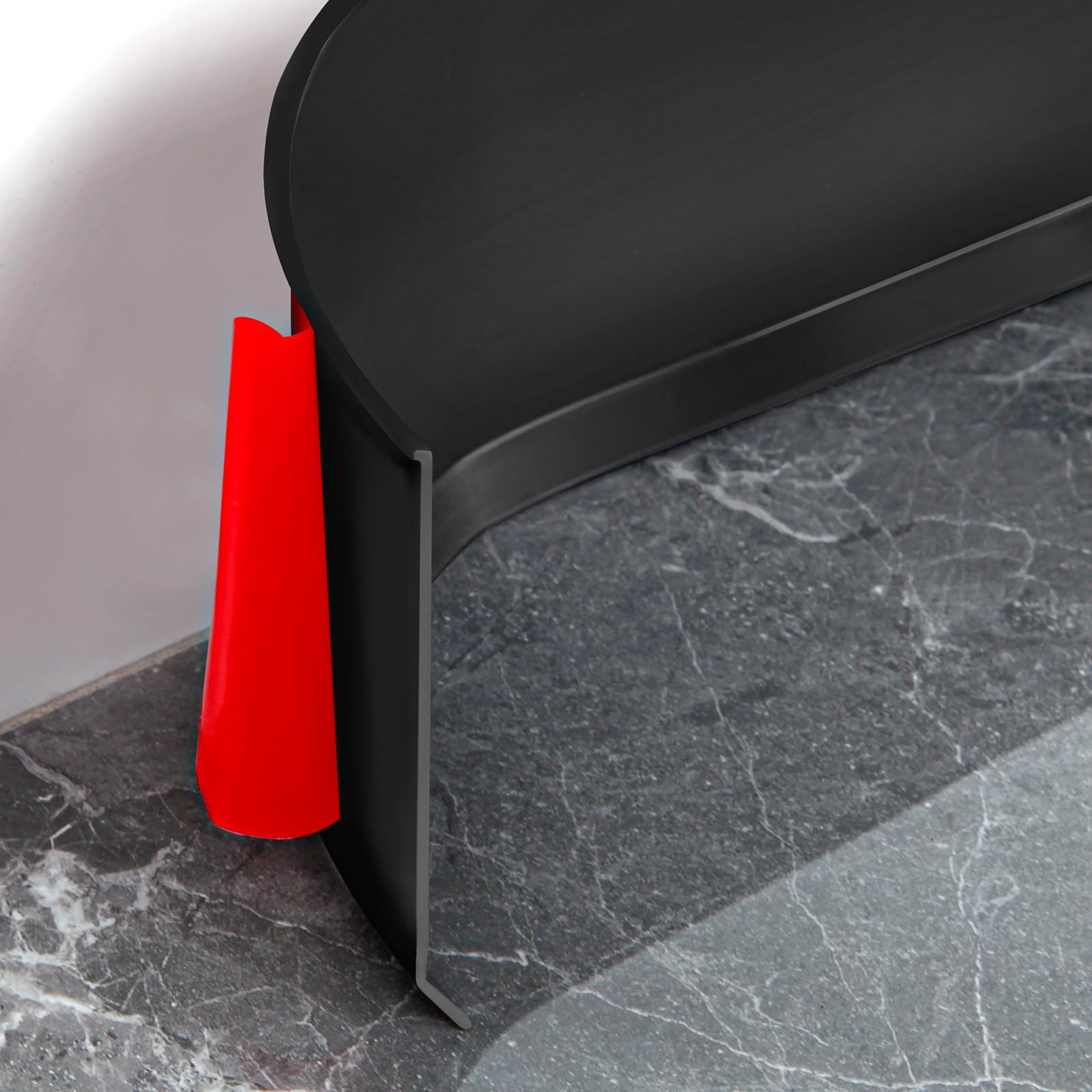 The Heonay baseboard trim in black shows an adhesive back for quick installation.
