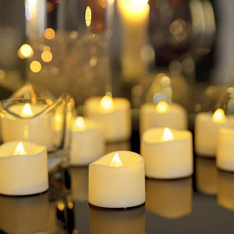 Homemory tea lights with ivory bases illuminate wedding centerpieces safely.
