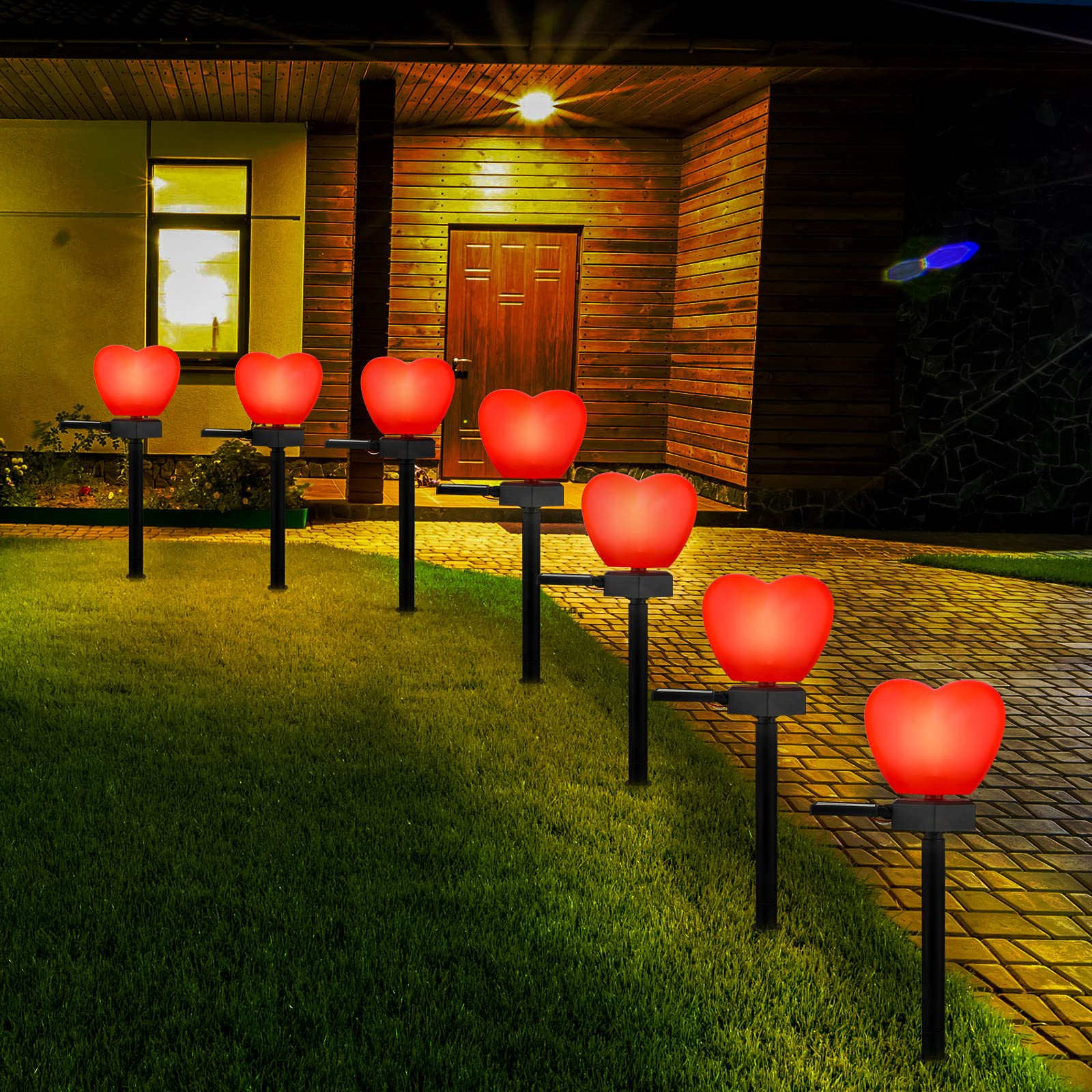Hortsun Valentine's heart solar light on stake illuminating a garden path with warmth
