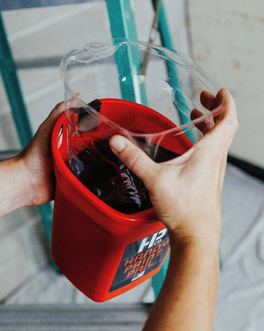 HP CO Magnetic brush holder attached to pail keeps tools secure.