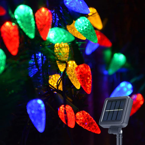 Huacenmy solar Christmas lights with 100 LED C6 strawberry ornaments illuminate outdoor trees.