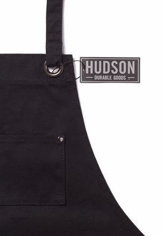 Hudson Durable Goods waxed canvas apron reinforced seams endure rugged daily tasks.