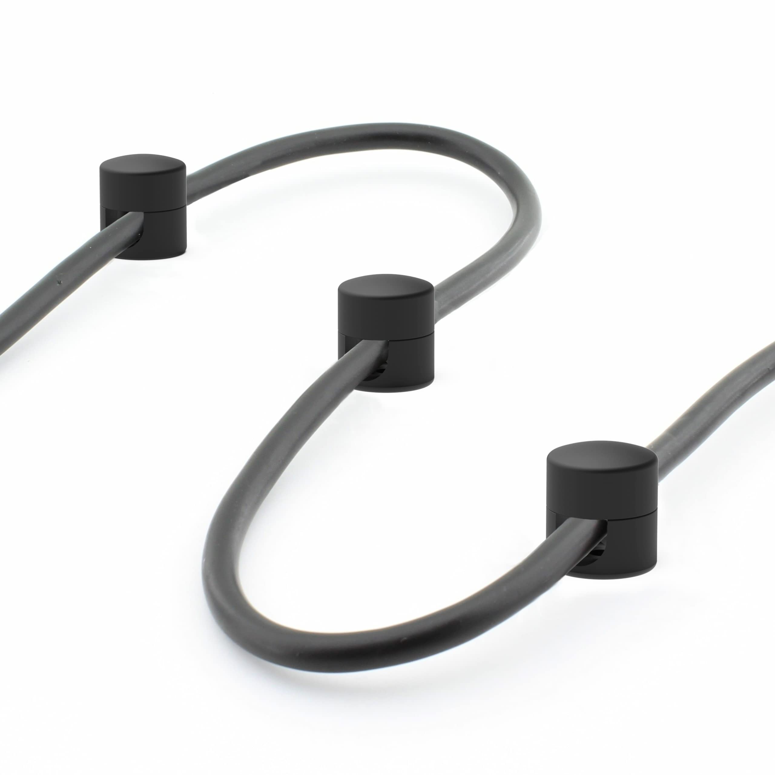 Cables stay aligned under a monitor with ICONIT anchors.