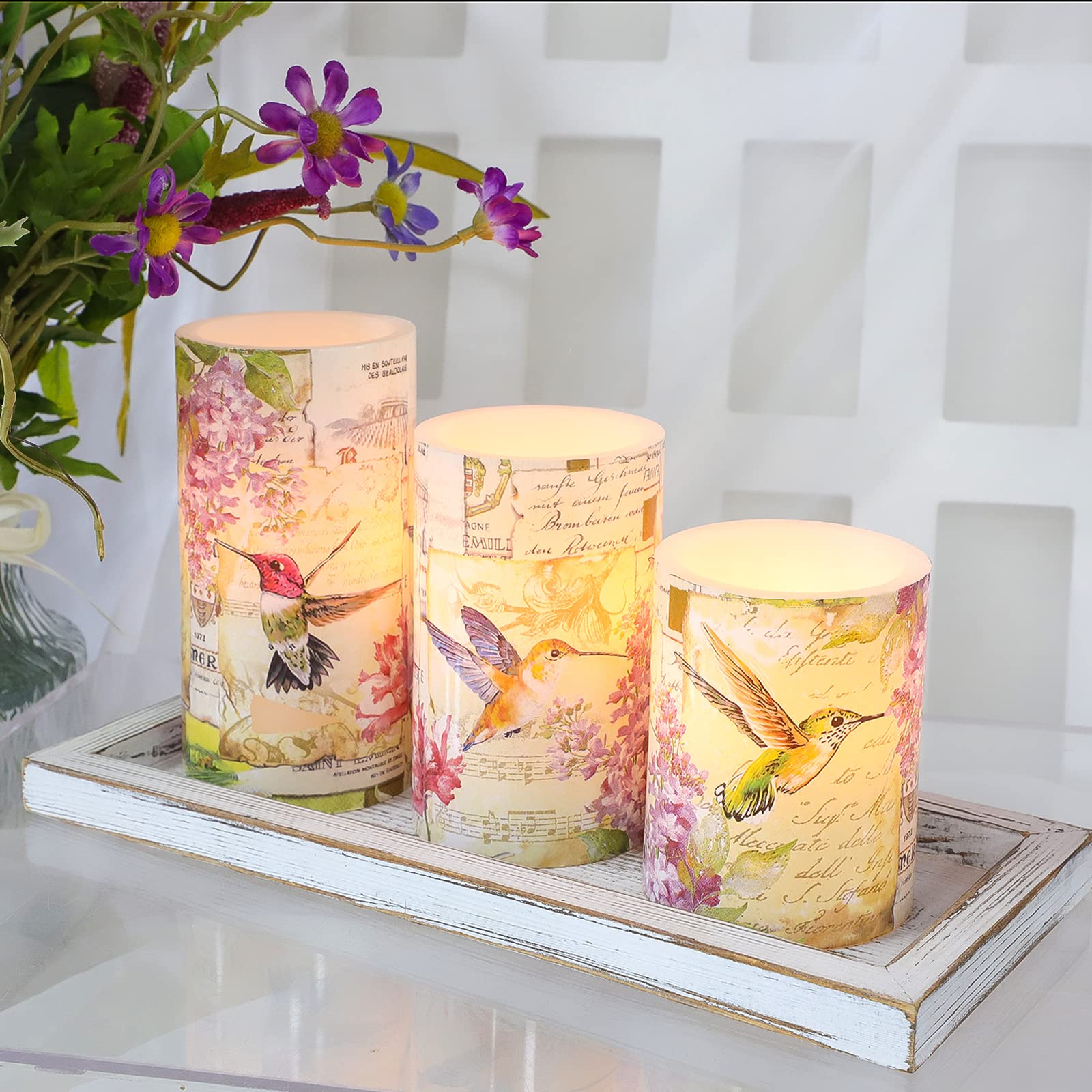 Immeiscent pink floral hummingbird candle enhances spring table centerpieces.