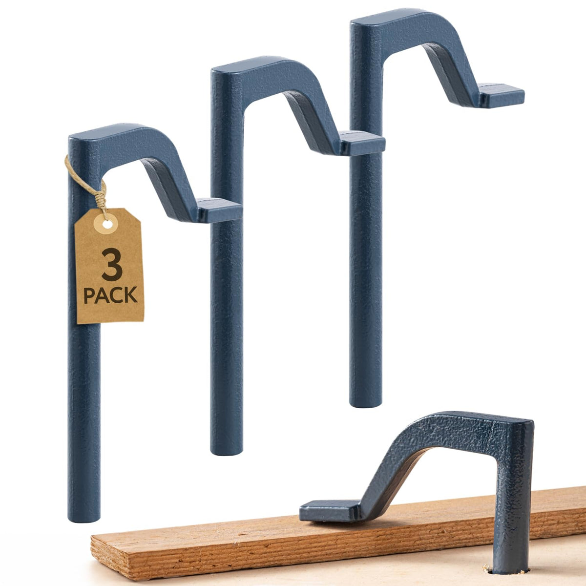 IMPRESA holdfast clamps in blue secure a workpiece on a bench for stability.