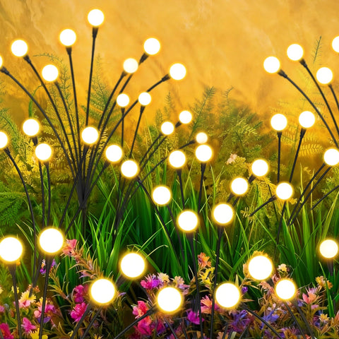 inBoboli Solar Firefly Lights with swaying stems illuminate your garden at night along pathways.