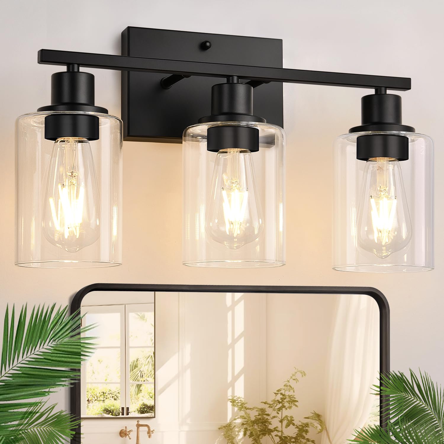 Indoi 3-light bathroom fixture with matte black finish and clear glass shades for modern elegance.