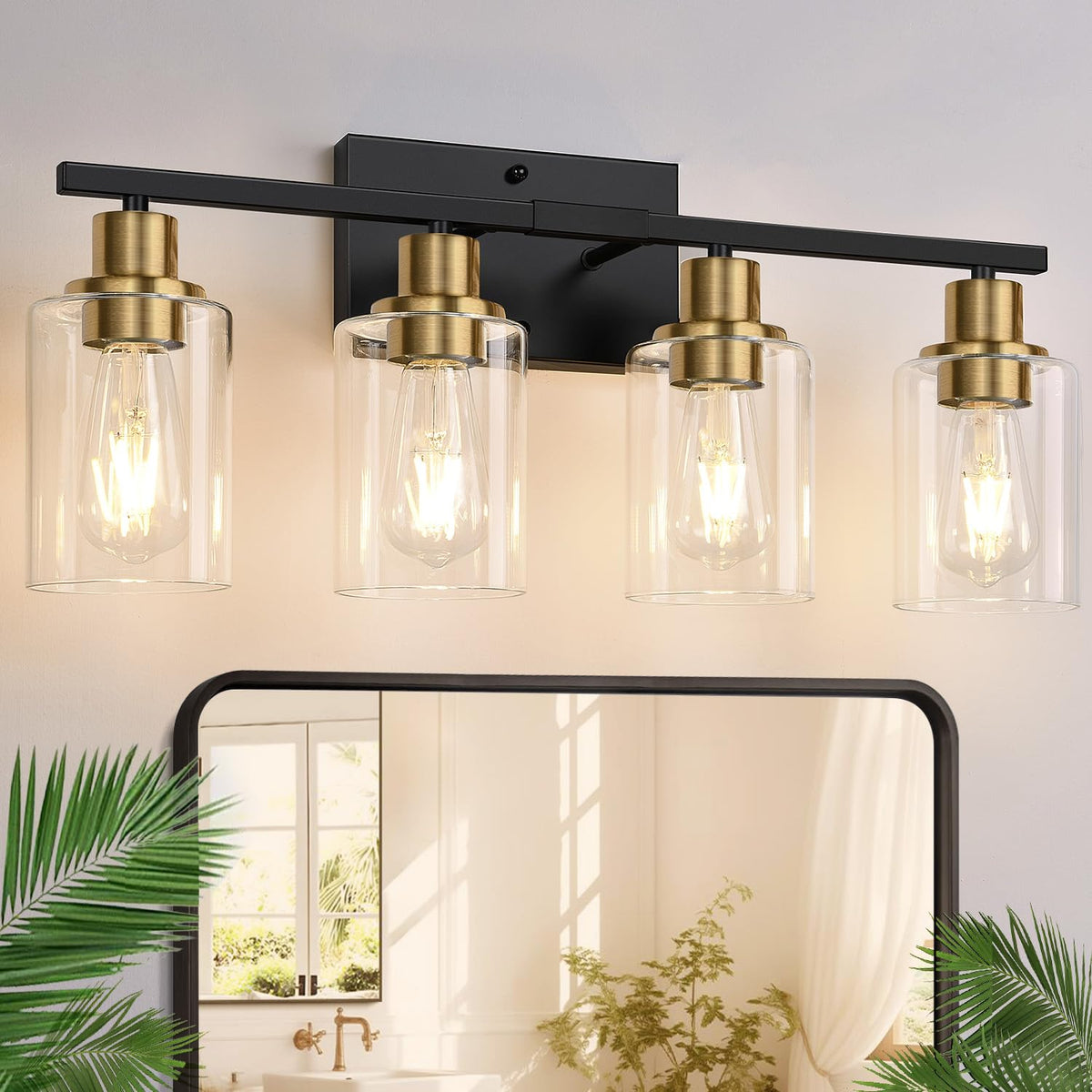 Indoi 4-light vanity with black-gold finish and clear glass shades for reflective bathroom lighting.