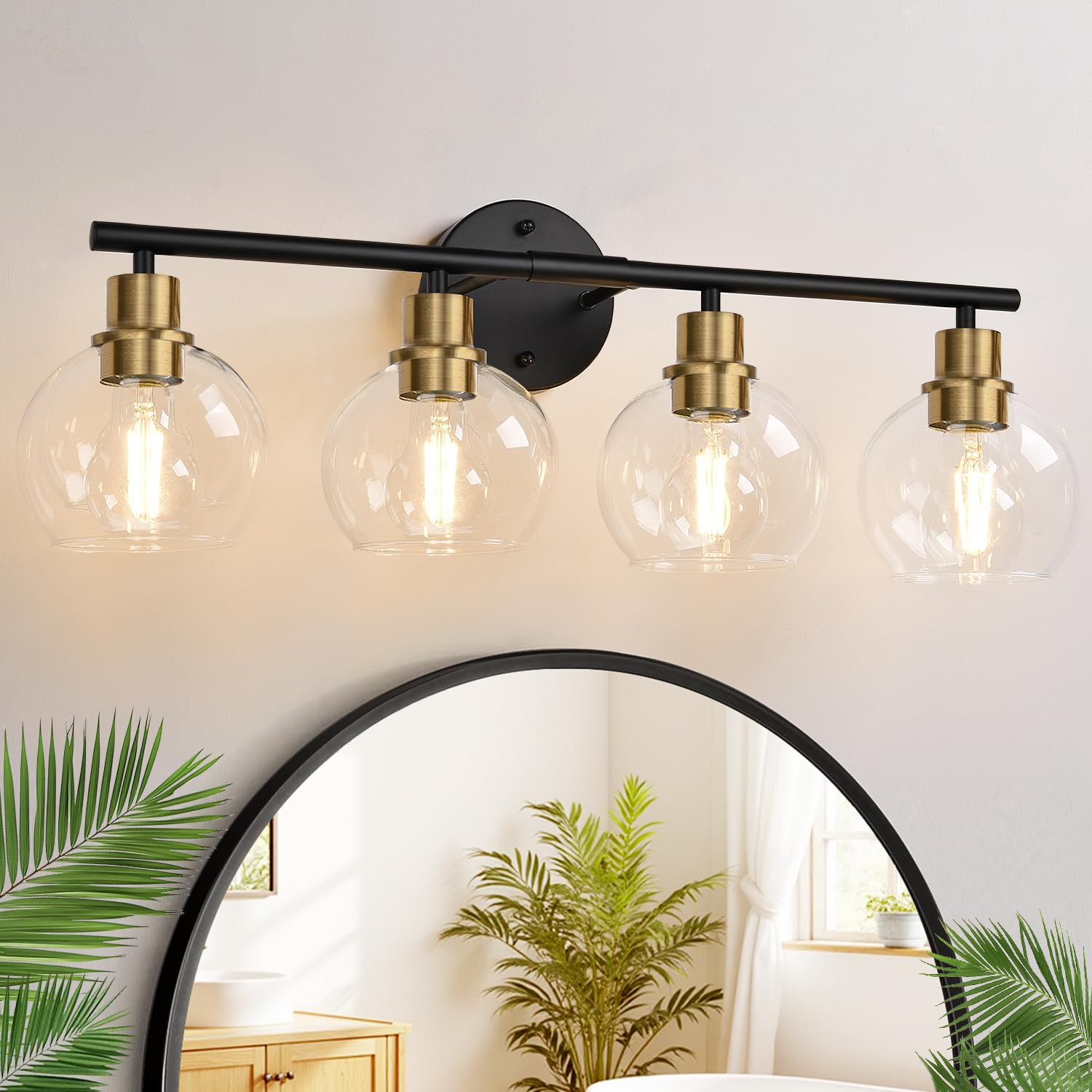 Indoi 4-light vanity fixture in black and gold with clear globe shades above the mirror.