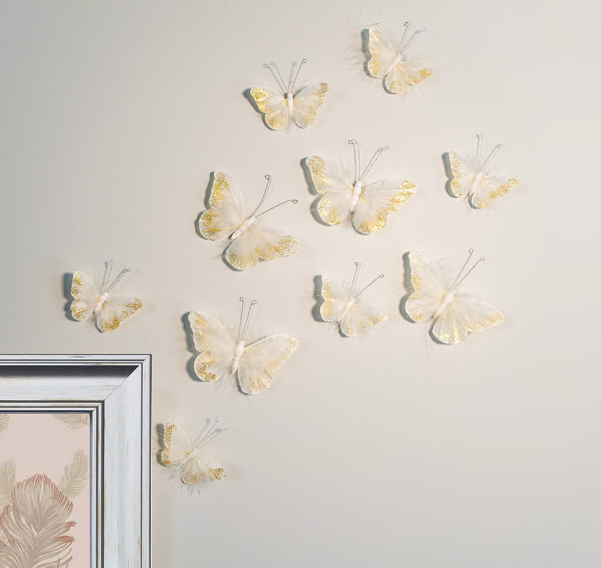 Inspired by Jewel butterfly wall decor with real feathers adds dimensional charm to any room.
