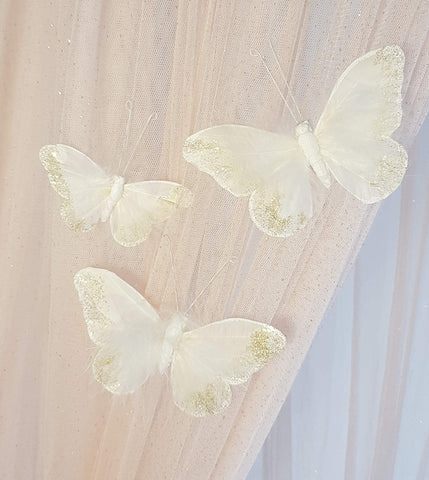Inspired by Jewel butterfly wall decor showcasing white and gold glitter wings on walls.