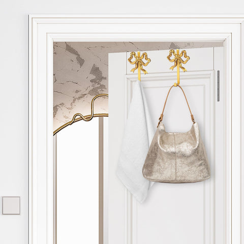 JarThenaAMCS gold bow door hook used as playful bedroom decor accent