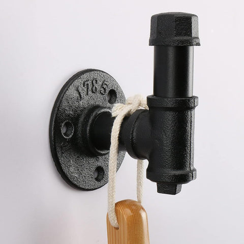Jeasor heavy-duty pipe hooks with vintage black finish on living room wall.
