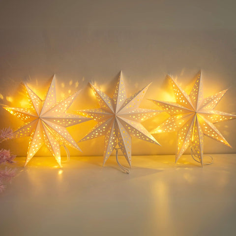 JINKEYULV paper star lanterns 3-pack illuminate windows with a warm, festive glow