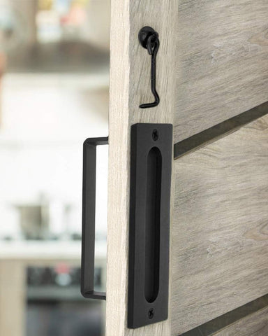 J JHOUSELIFESTYLE lock latch feature on matte black barn door handle.