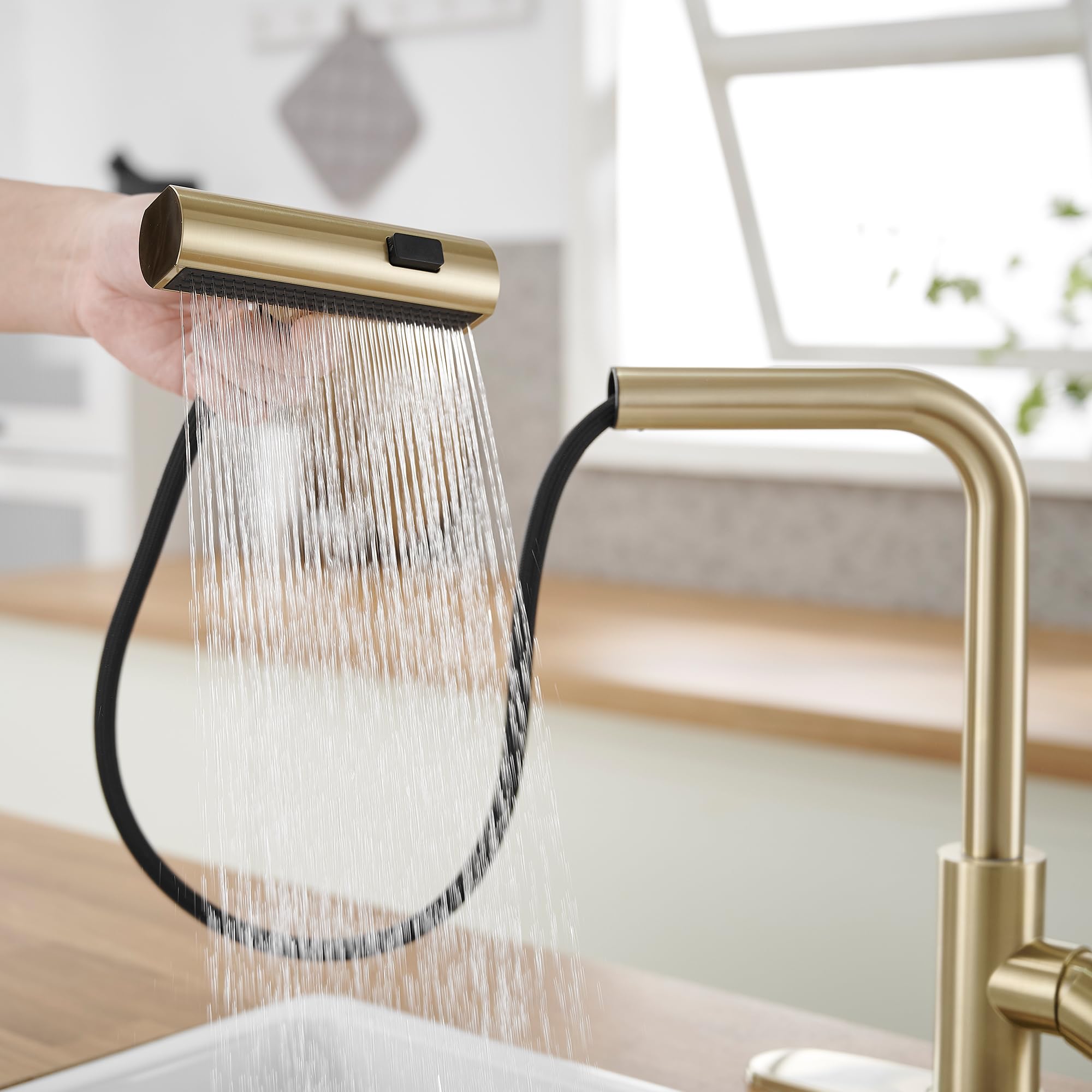 JOOM Gold faucet retractable hose extending across the sink