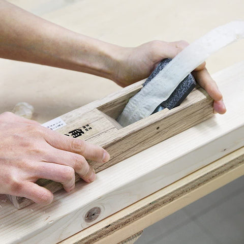 KAKURI KanNA block plane handle grip highlighted for controlled two-handed planing.