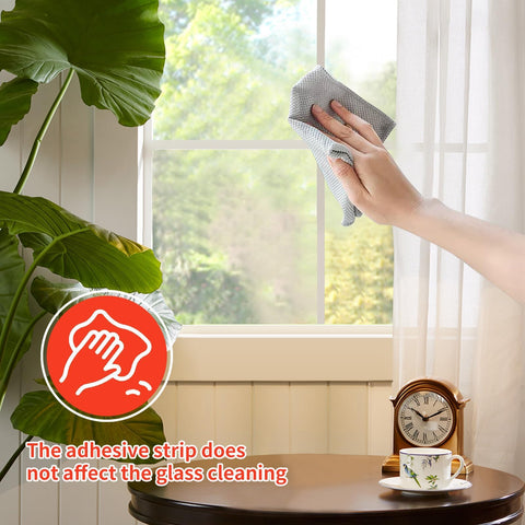 KEOHOLI adhesive back testing on indoor window shows strong grip.