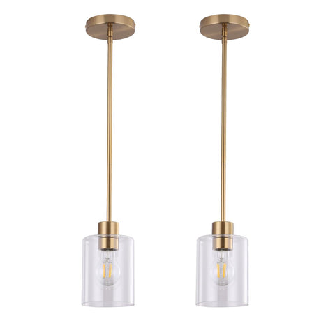 KLSS brass pendant light with clear glass shade over a kitchen island.