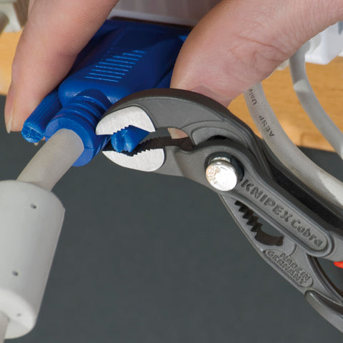 KNIPEX Cobra Pliers in use gripping pipes and nuts with self-locking action