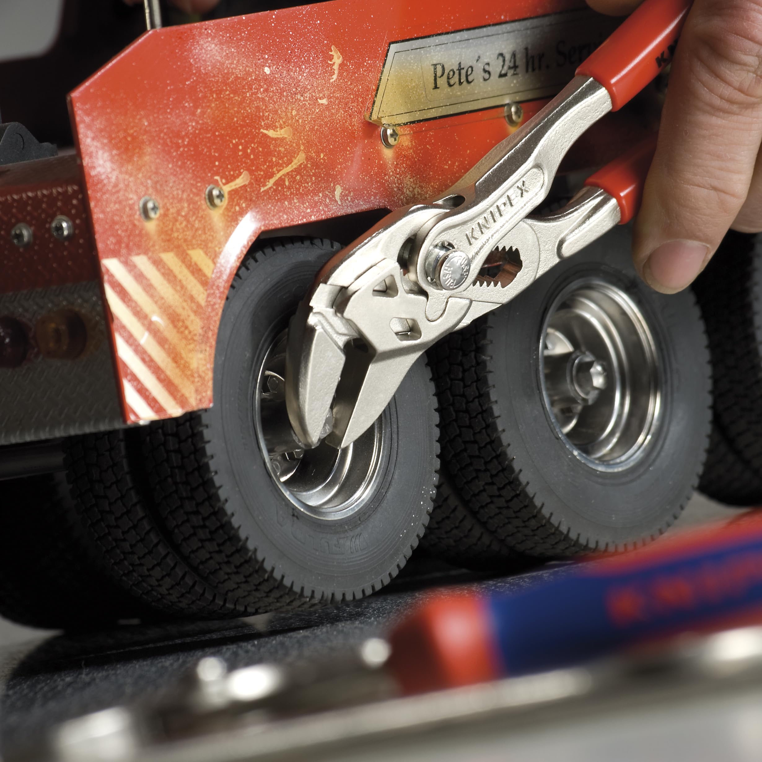 KNIPEX 9K 00 80 45 US pliers wrench in use for quick gripping and release.