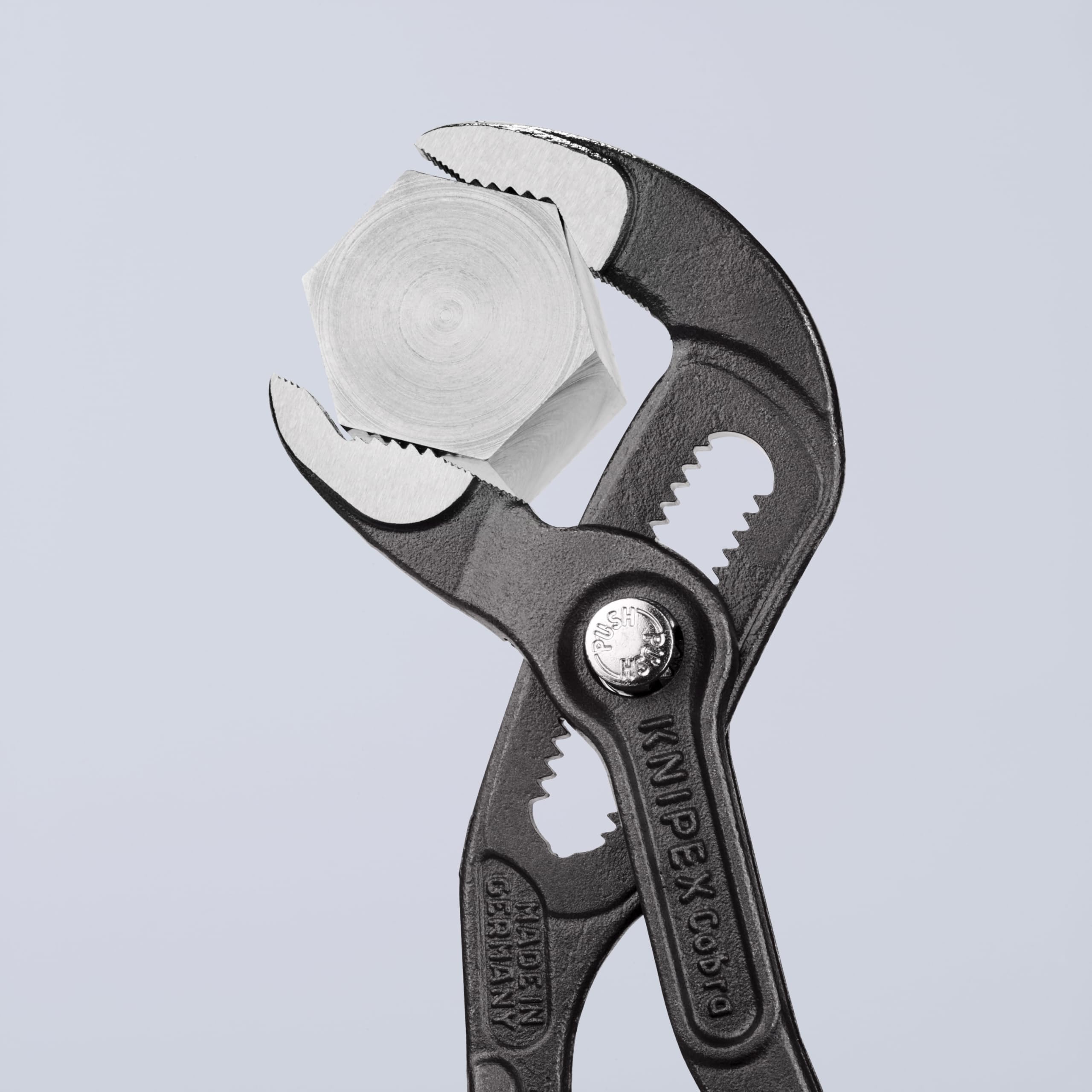 Knipex Cobra Pliers 8702180 demonstrating self-locking grip on pipes and nuts