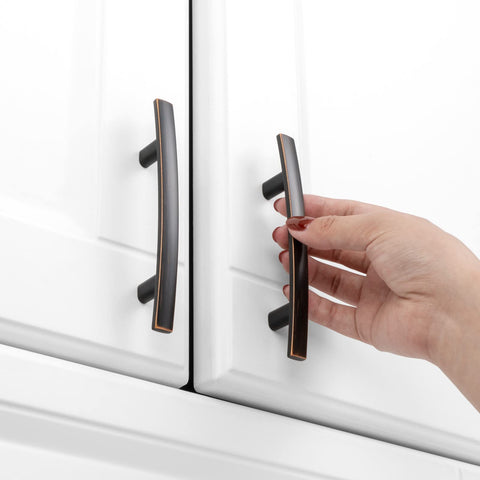 KOOFIZO curved bronze handle on a drawer provides comfortable grip.