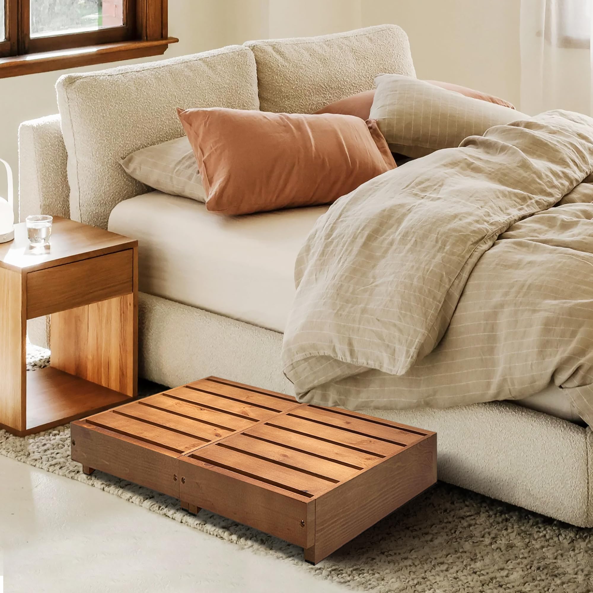 Koretech step stool near a high bed demonstrates versatile reach at home.