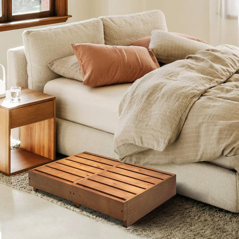 Koretech step stool near a high bed demonstrates versatile reach at home.