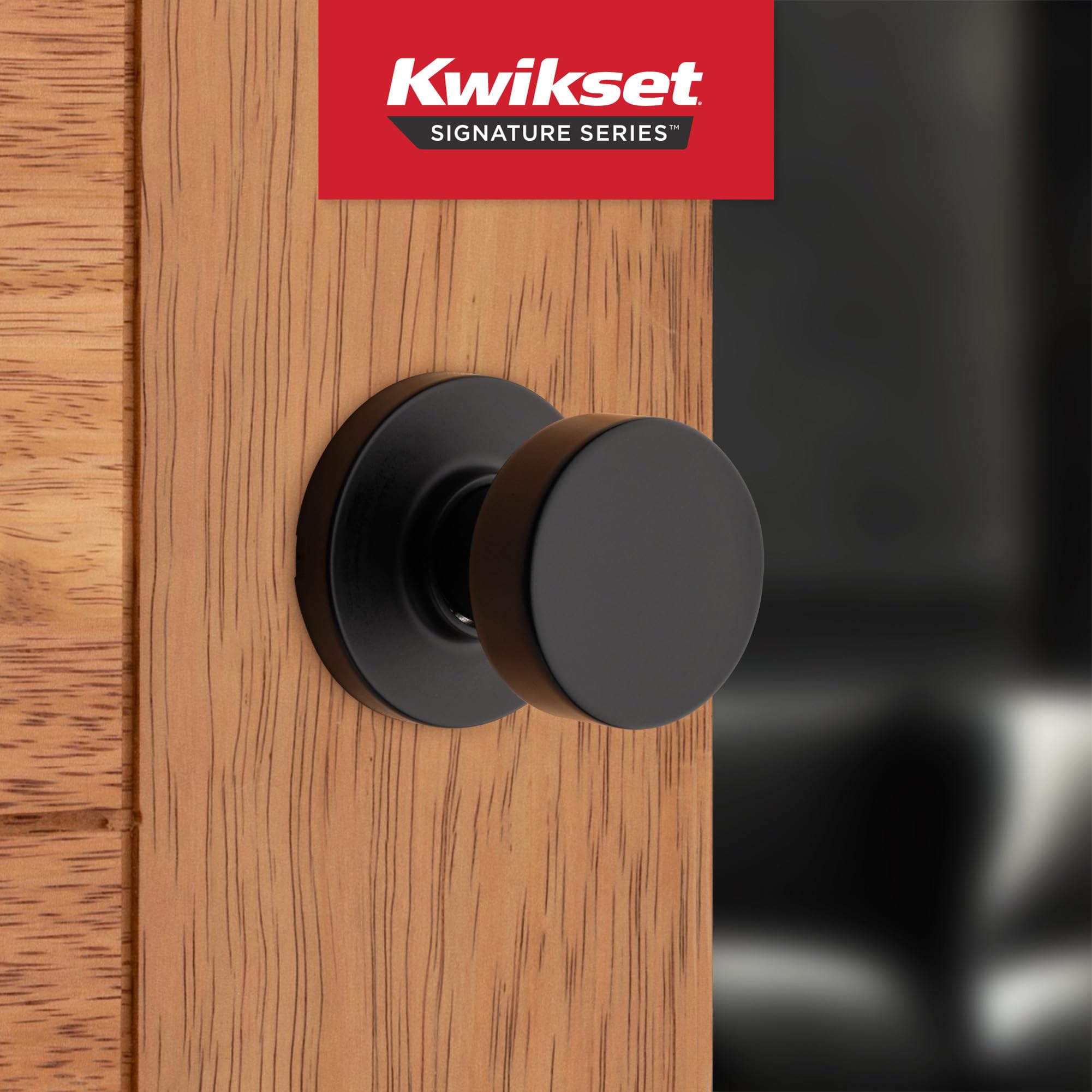 Kwikset Pismo matte black round rose highlights contemporary interior styling.