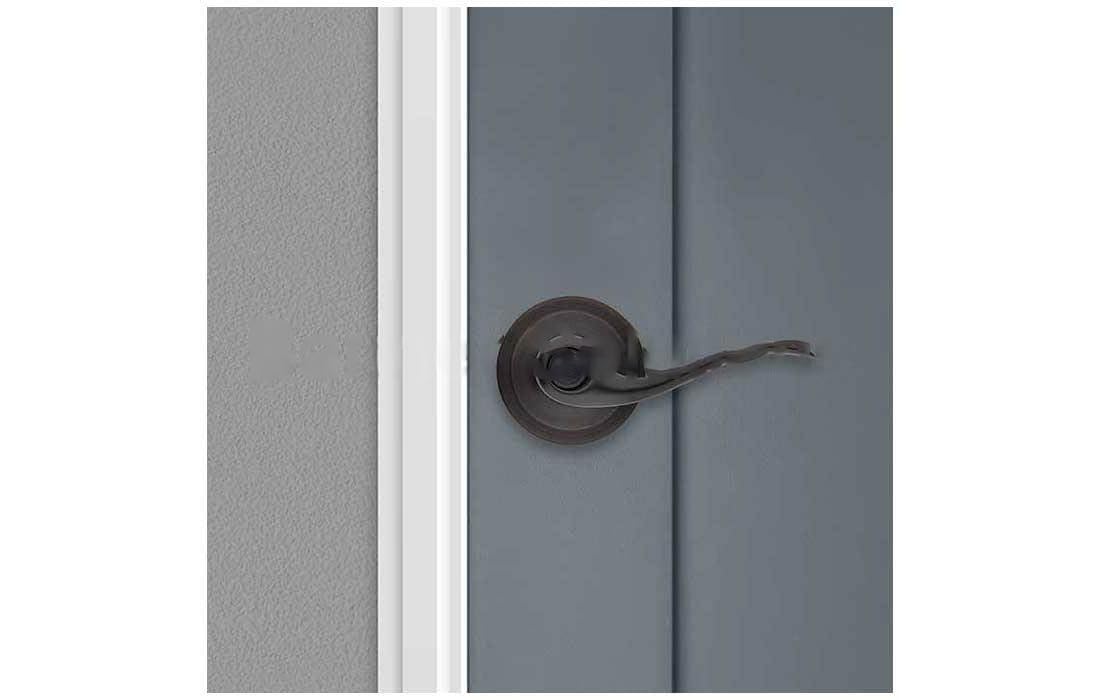 Close-up of Kwikset Tustin interior door handle showing wave-inspired design
