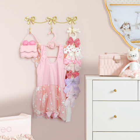 Coquette room decor with KYIAANY gold bows on the wall