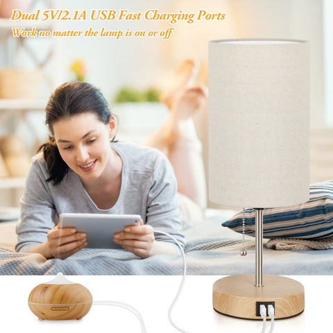 Lakumu dual USB table lamp powering devices from the bedside
