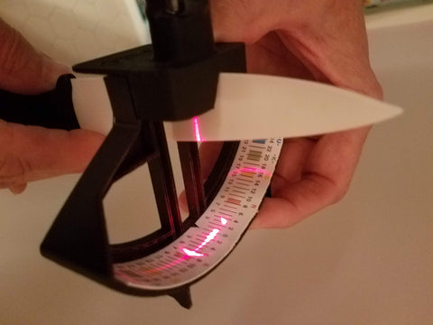 LEONARDS WAY Laser Knife Edge Reader on sharpening stone captures real-time edge feedback.