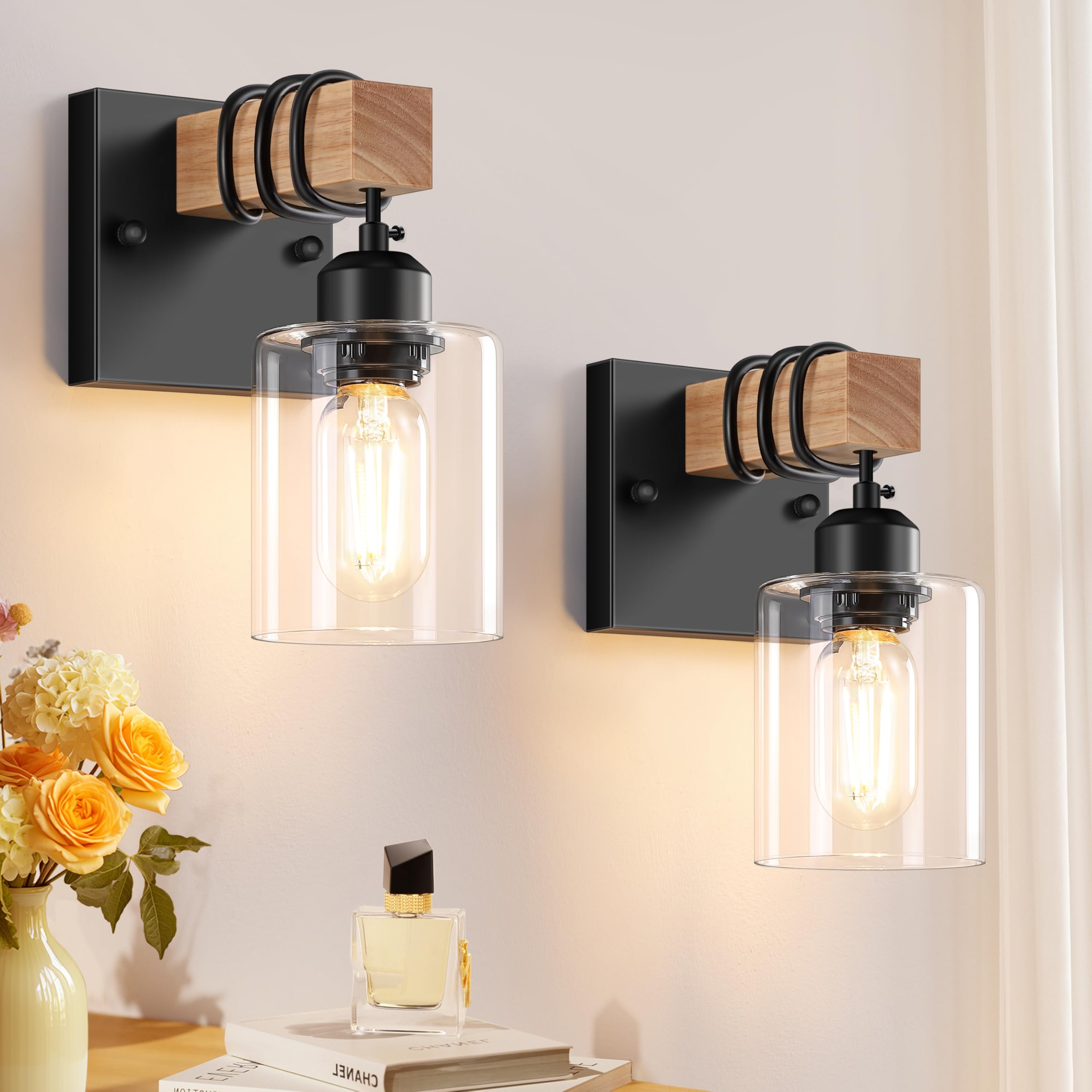 Licperron two-sconces in matte black with clear glass shades brighten a stylish bathroom vanity.