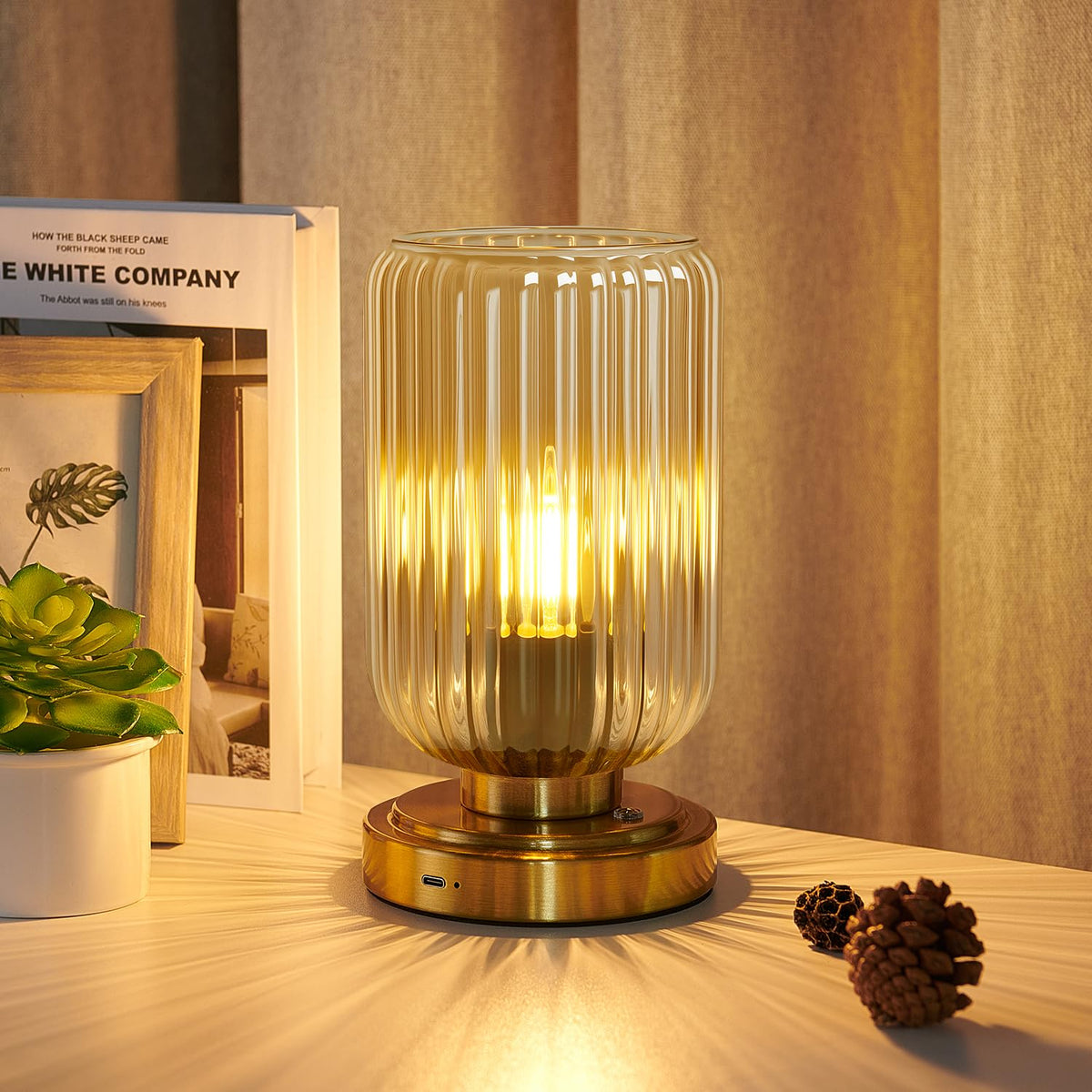 LightRound table lamp with amber shade for cozy reading ambiance.