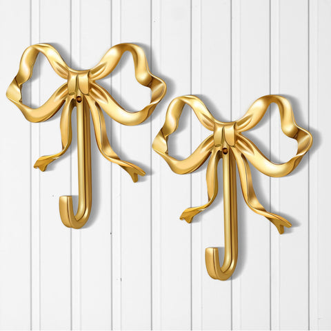 Lineshading gold bow hook wall mount for coats and bags in a hallway