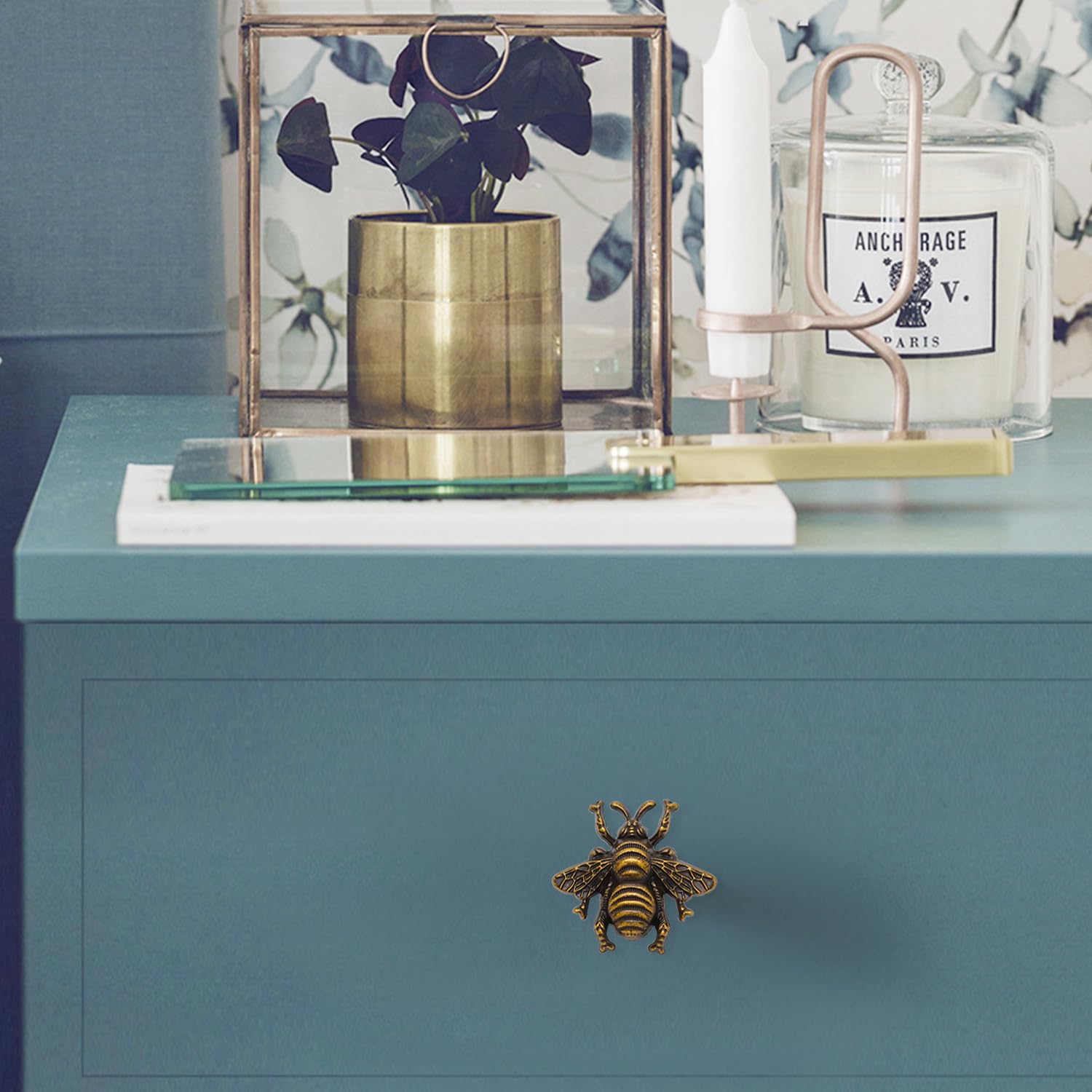 Bronze bee drawer pull for rustic cabinet appeal.