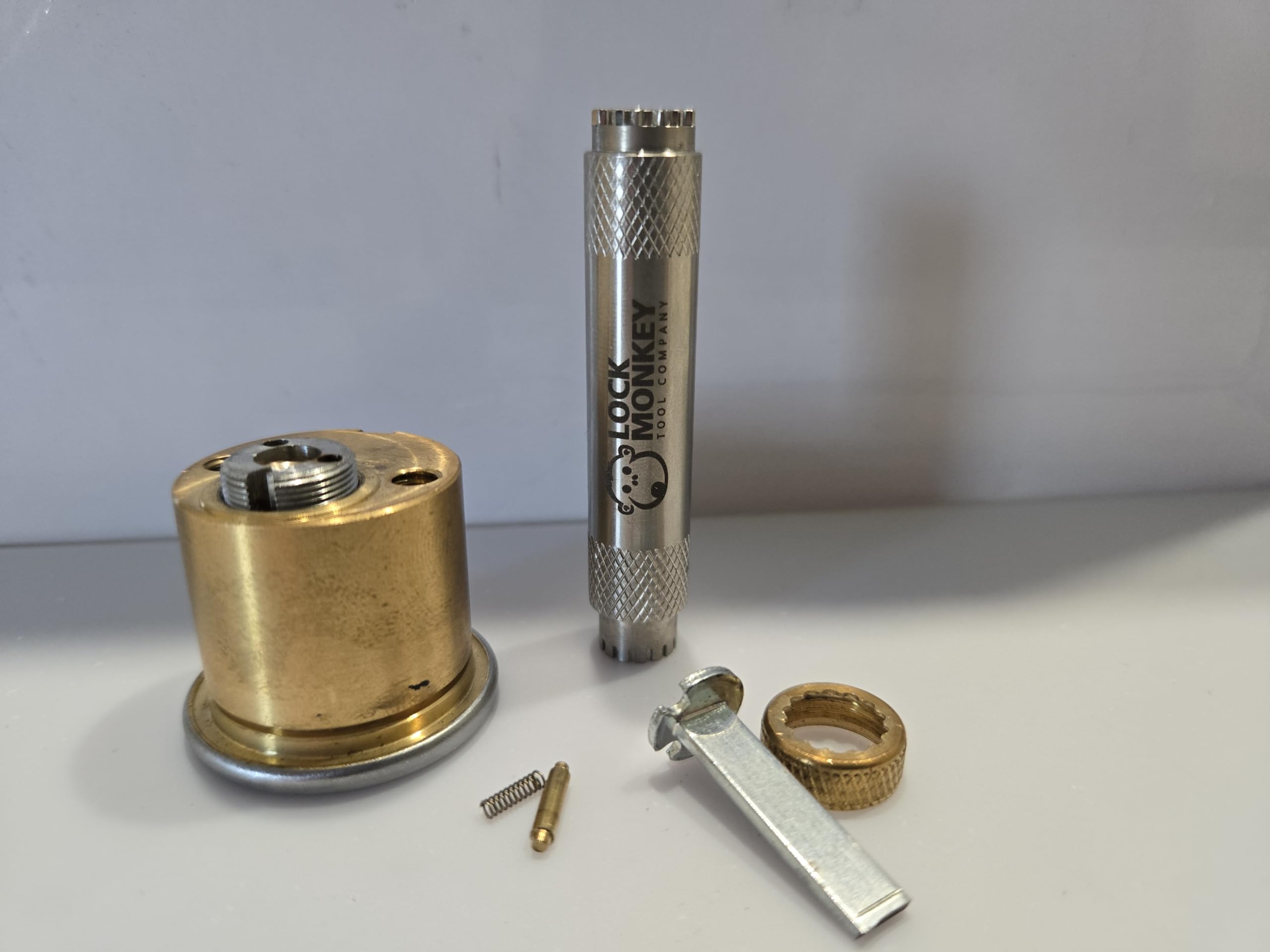 Lock Monkey back cap depresses retaining pin to enable rekeying.