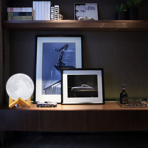 LOGROTATE Moon Lamp sits on a bedside table as a comforting night light