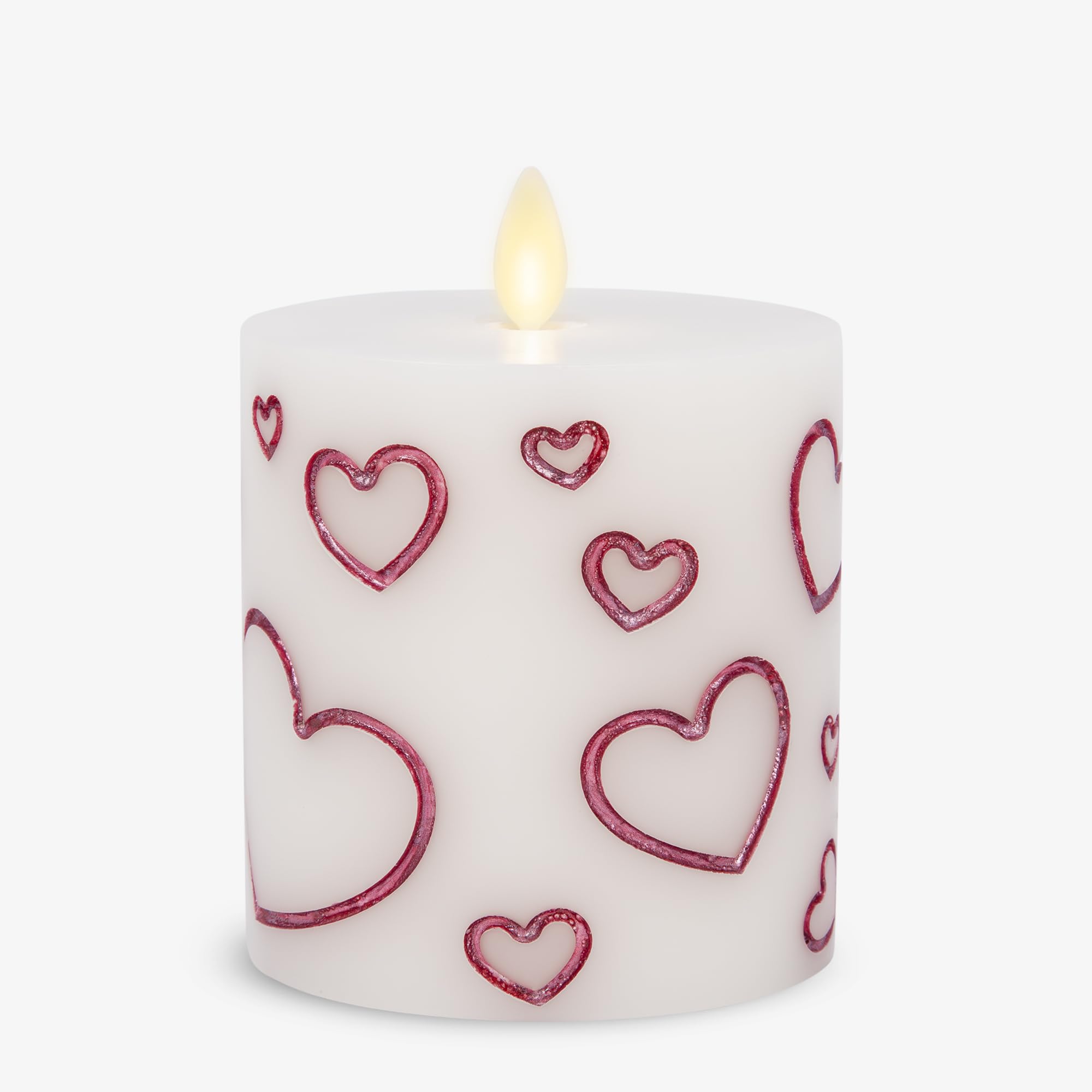 Luminara Debossed Hearts Pillar Magenta closeup showing textured hearts and warm glow