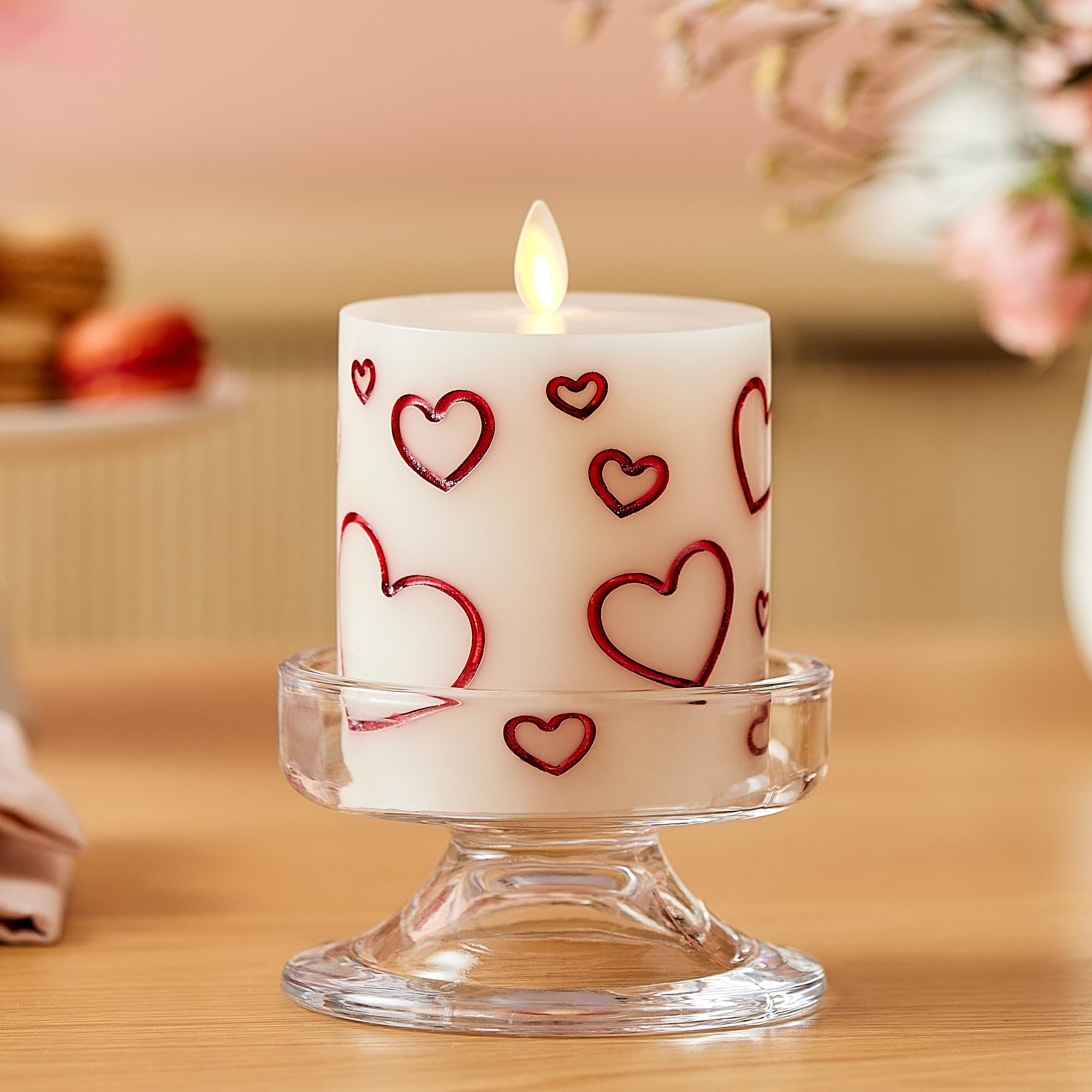 Luminara Debossed Hearts candle on dining table creates warm dinner centerpiece.