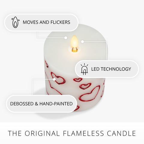 Luminara Debossed Hearts red pillar on mantel emits soft, safe glow.