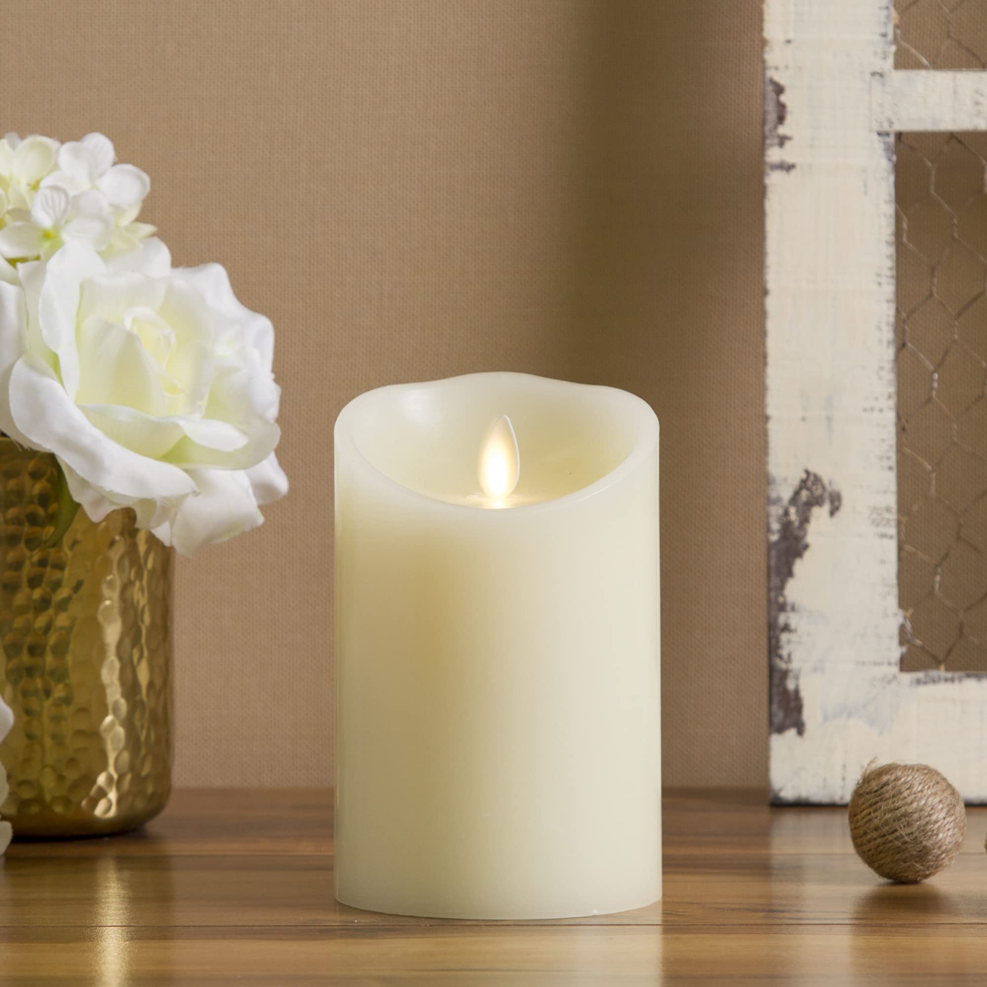 Luminara flameless ivory pillar candle enhances table centerpieces with a warm, realistic glow.