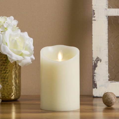 Luminara flameless ivory pillar candle enhances table centerpieces with a warm, realistic glow.
