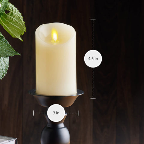 Luminara ivory pillar candle emits warm white flame for inviting decor.