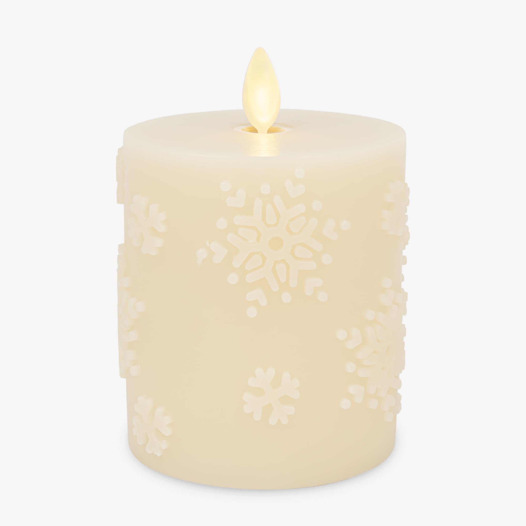Luminara White Swan Snowflake embossed candle glows as a cozy winter centerpiece