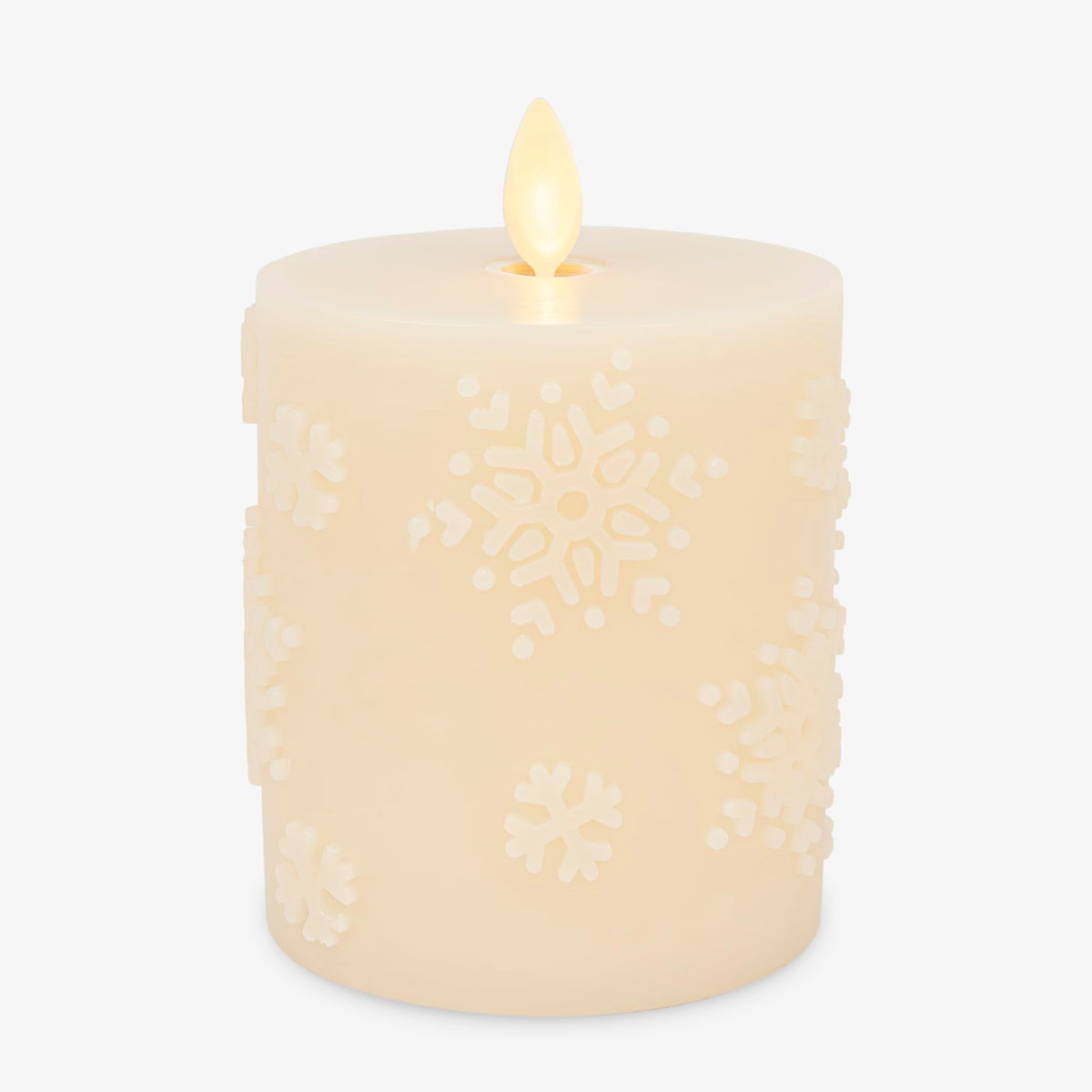 Luminara White Swan Snowflake embossed candle glows as a cozy winter centerpiece