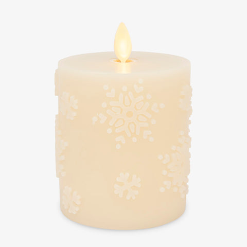 Luminara White Swan Snowflake embossed candle glows as a cozy winter centerpiece